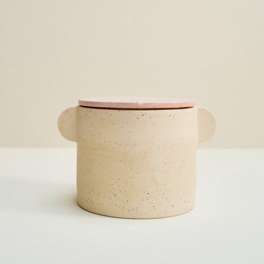 Speckled storage jar with a pink lid